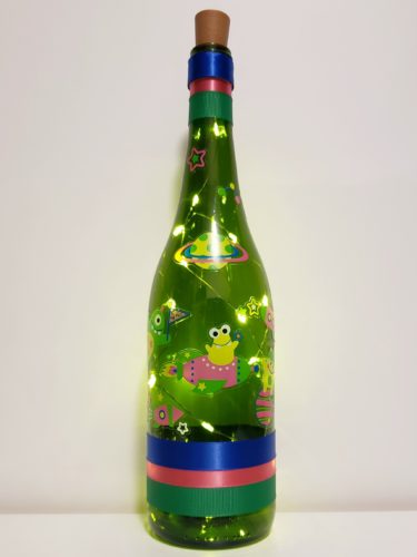 Bottle light with space monsters and planets.