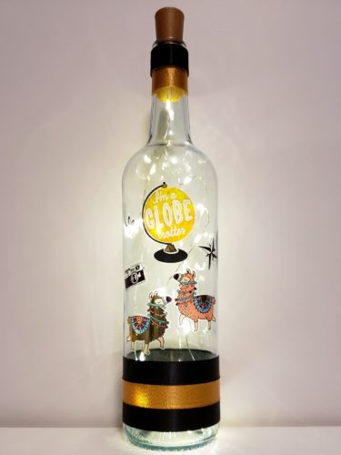 Bottle light with two llamas and a globe with "I'm a globe trotter" in the center.