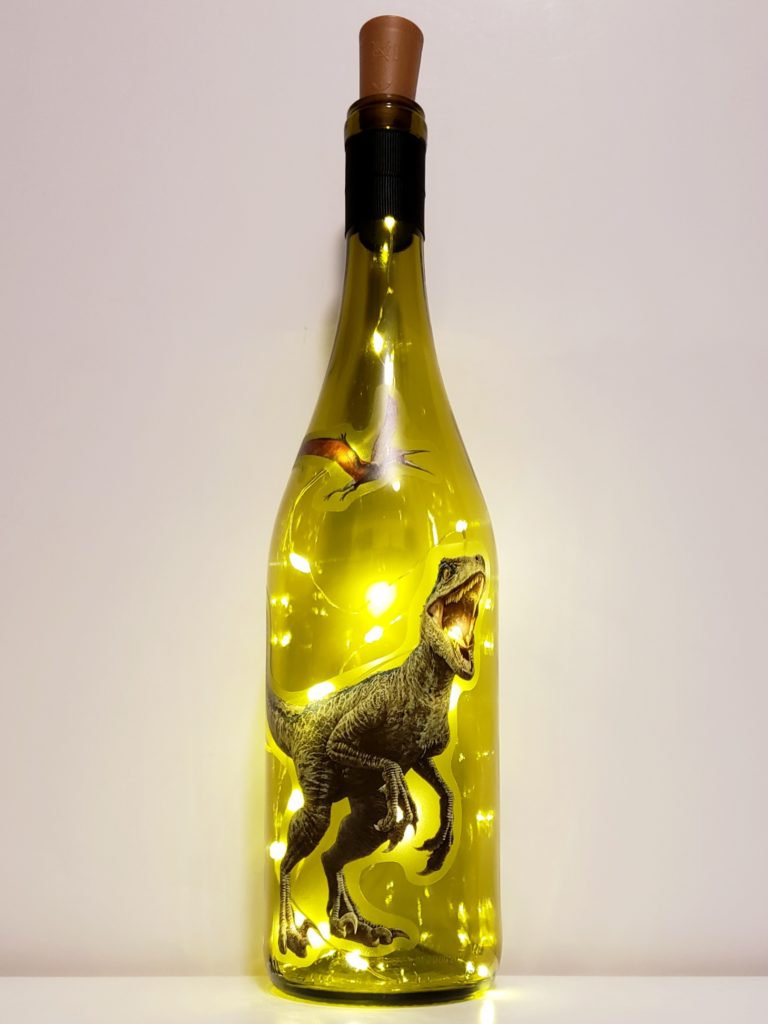 Bottle light with t-rex and flying dinosaur from Jurassic Park.