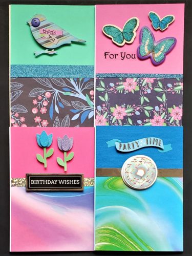 Four pack of birthday and mixed use cards in bright pink, blue and green.