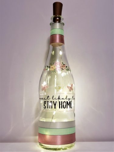 Photo grid of a bottle light with flowers and "Most likely to stay home".
