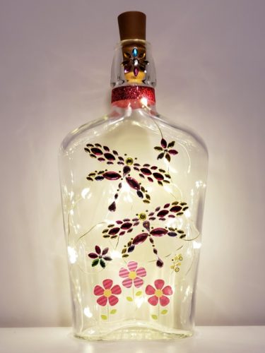 Bottle light with jewelled dragonflies and flowers.