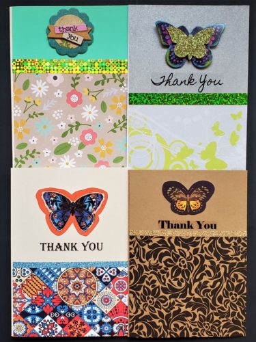 Four pack of thank you cards in bold prints with butterfly decorations.