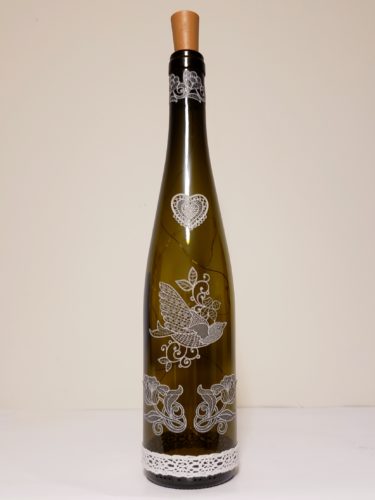 Bottle light with a lace bird, flowers and hearts.