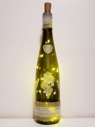 Bottle light with lace hearts and flowers, and burlap and lace trim.