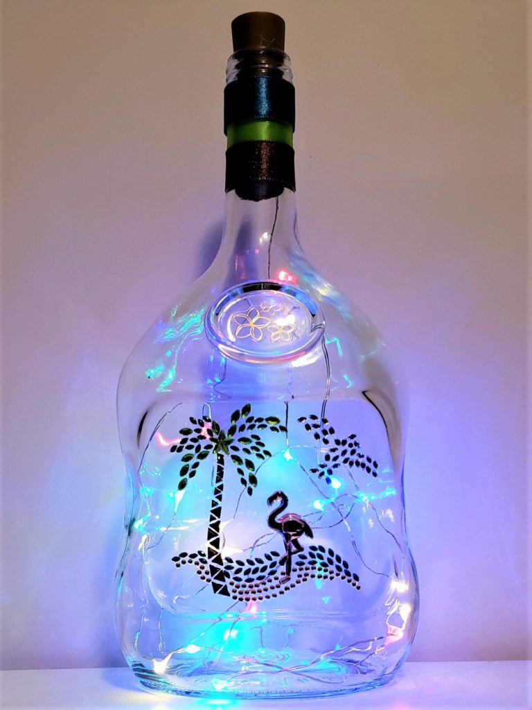 Bottle light with a jewelled beach scene.