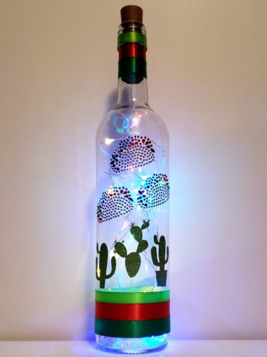 Bottle light with three jewelled tacos and sparkly green cacti.