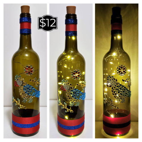 Bottle light featuring a jewelled parrot and red and blue matching ribbons.