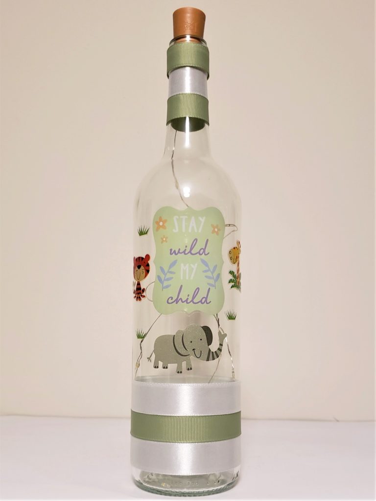 Bottle light with jungle animals and the phrase, "Stay wild my child".