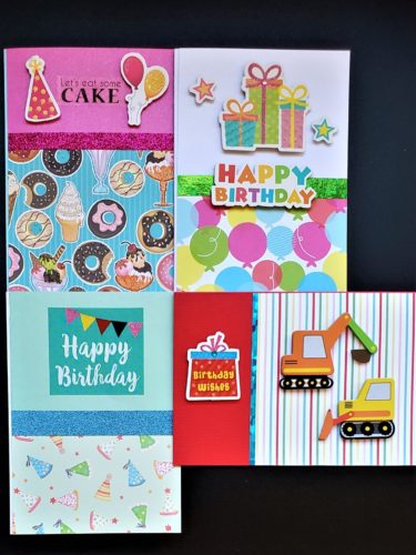 Four pack of adult and kids birthday cards with balloons, sweets, party hats and construction vehicles.