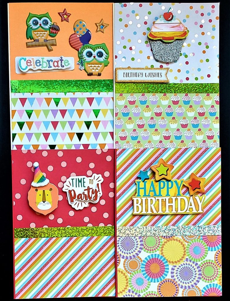 Four pack of kids birthday cards with cupcakes, owls and a lion.