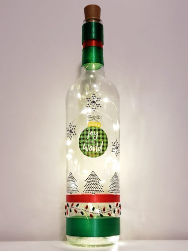 Bottle light with "Joy to the world", jewelled trees and snowflakes, and a jewelled accent around the bottom.