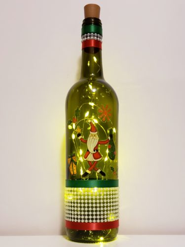 Bottle light featuring a quirky Santa holding a sack, and a pearl wrap around the bottom.