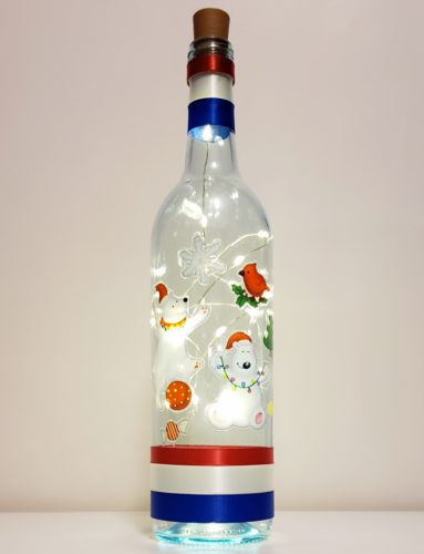 Bottle light featuring two polar bears, a snowflake, candy and bird.