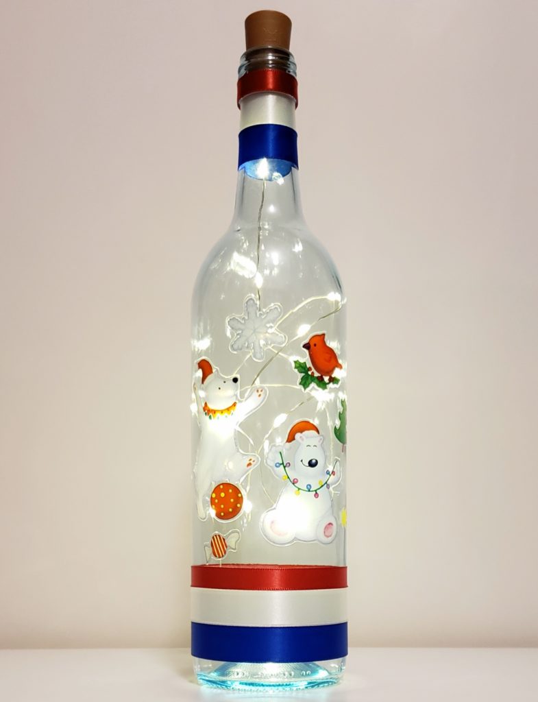 Bottle light featuring two polar bears, a snowflake, candy and bird.