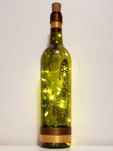 Bottle light featuring matte metallic gold butterflies and the phrase, "Carpe Diem".