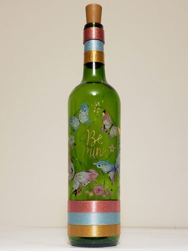 Bottle light featuring "Be mine" surrounded by watercolour-style butterflies.