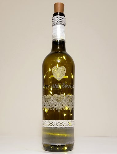 Bottle light featuring lace hearts and the phrase, "You are loved".