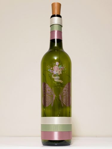 Bottle light with two butterflies facing each other and a pastel floral bouquet.