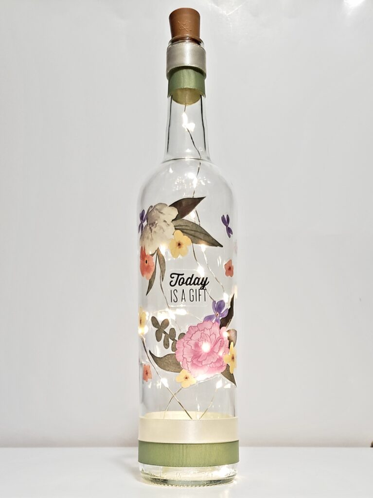 Bottle light with flowers surrounding "Today is a gift".